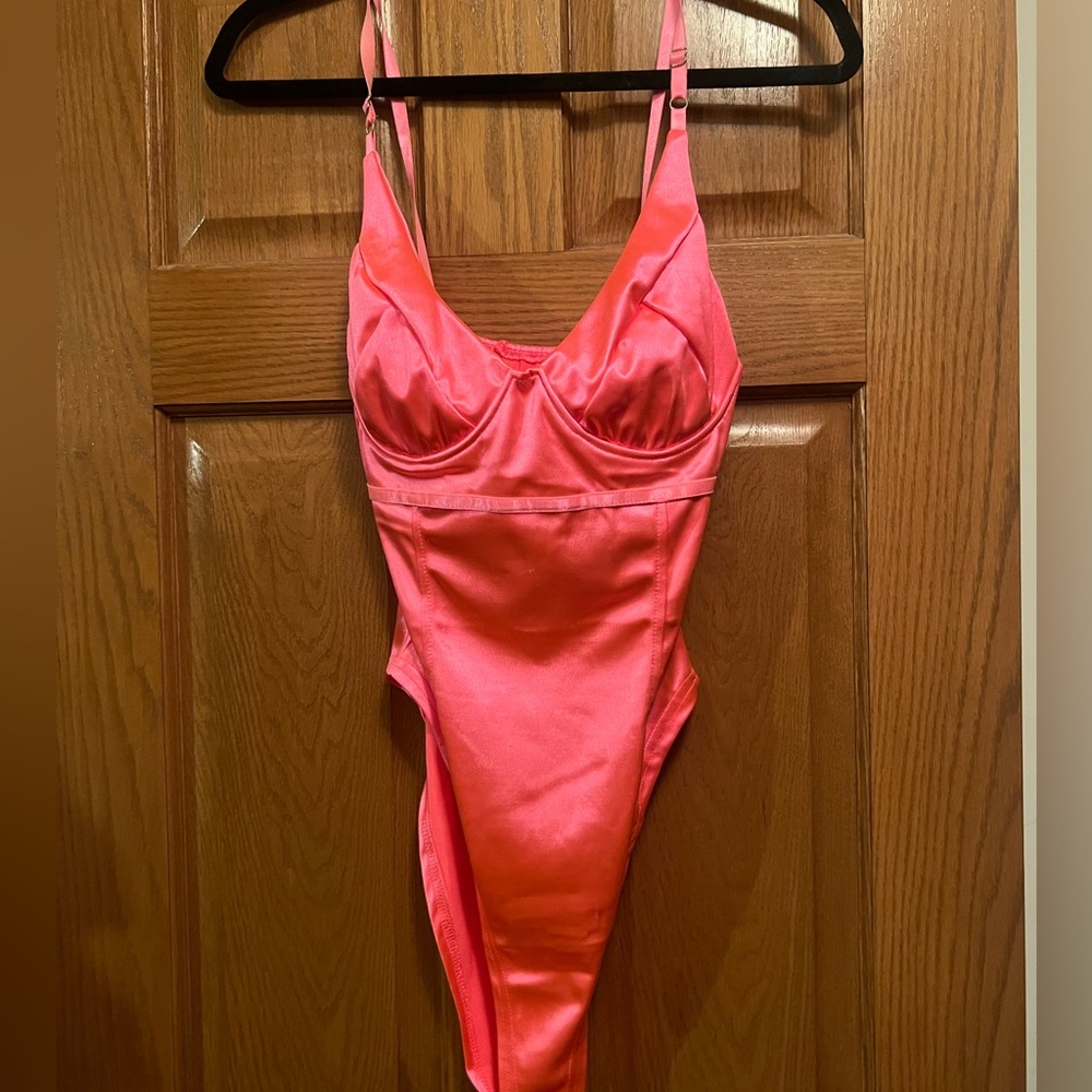 Neon Pink Body suit. Size 4, stretchy material. Brand new, never worn.